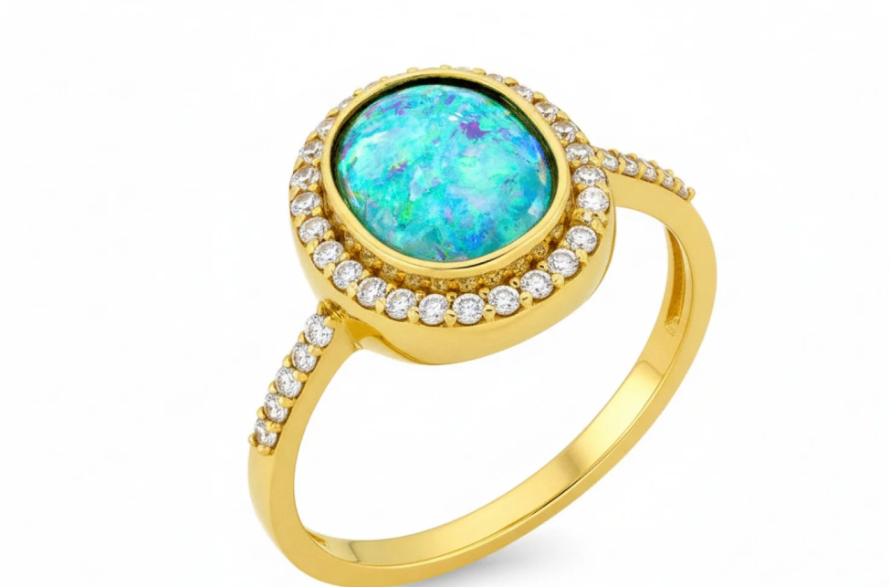 Zlatý prsteň s modrým syntetickým kameňom a zirkónmi